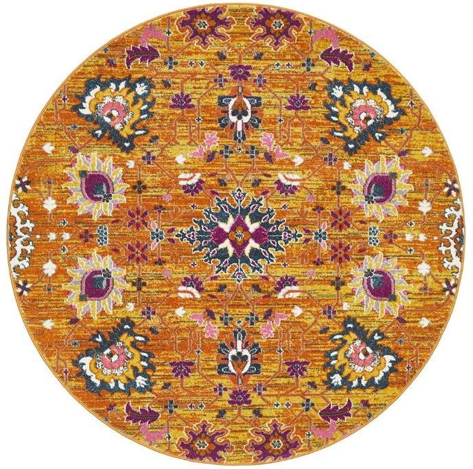 A round orange rug with a geometric pattern featuring floral-like designs