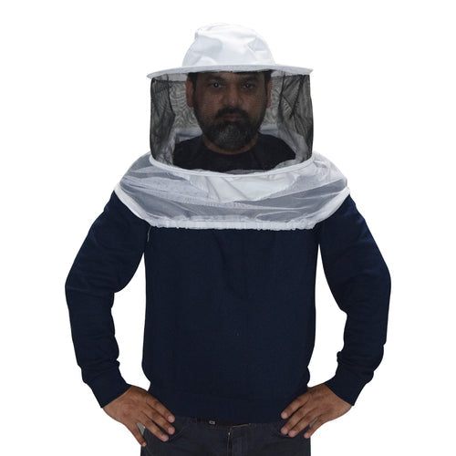 Person wearing a beekeeping suit with a white hat and face mask on a white background