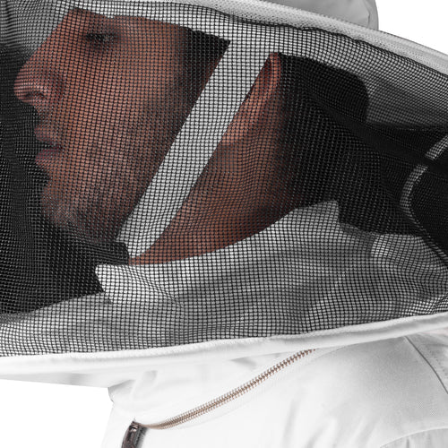 Person wearing a white beekeeping suit with a mesh face guard.