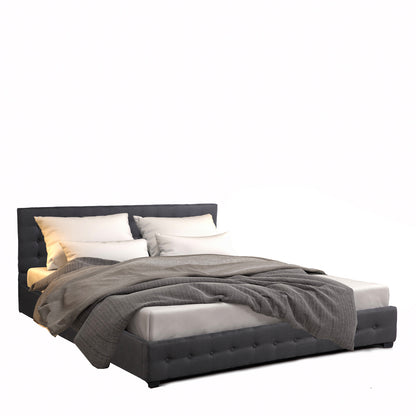 Bed with gray bedding and pillows on a white background
