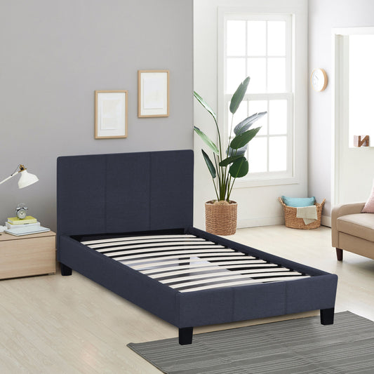 Blue bed frame in a room with a window, plant, and furniture.