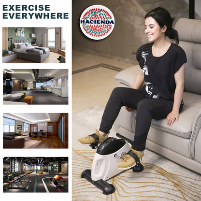 Woman using a mini exercise bike on a couch with 'Hacienda' branding.