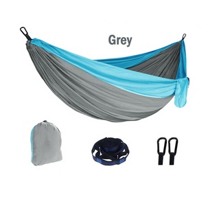 A portable outdoor camping hammock in grey and blue, displayed with its carrying storage bag and spread out showing the full hammock. The image also includes icons indicating fast shipping within Australia and a 260x140cm size specification.