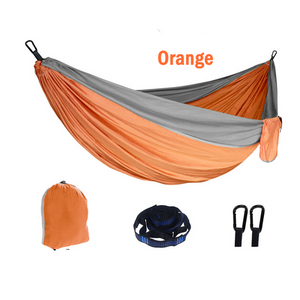 An outdoor camping hammock in orange and gray, displayed with its portable design and including a storage bag.