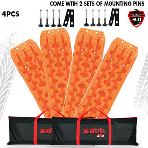 Four orange X-BULL recovery tracks placed side by side with mounting pins and bolts, against a white background.