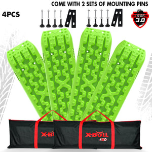 A set of green X-BULL recovery tracks with mounting bolts and pins, displayed alongside a black and red carrying tote.