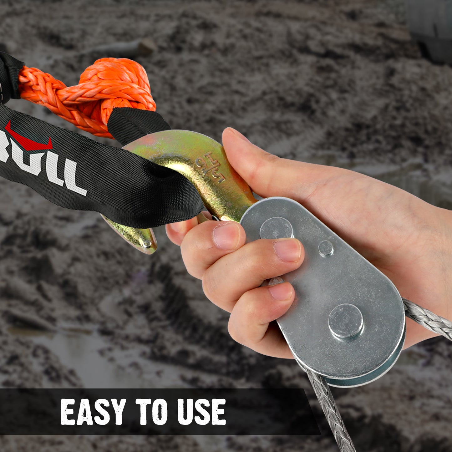 Hand using a pulley system with a rope and 'Bull' branding, on a textured background.