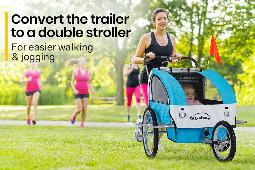 Woman pushing a blue and white bicycle trailer with a child inside, with text indicating it can be converted to a double stroller.