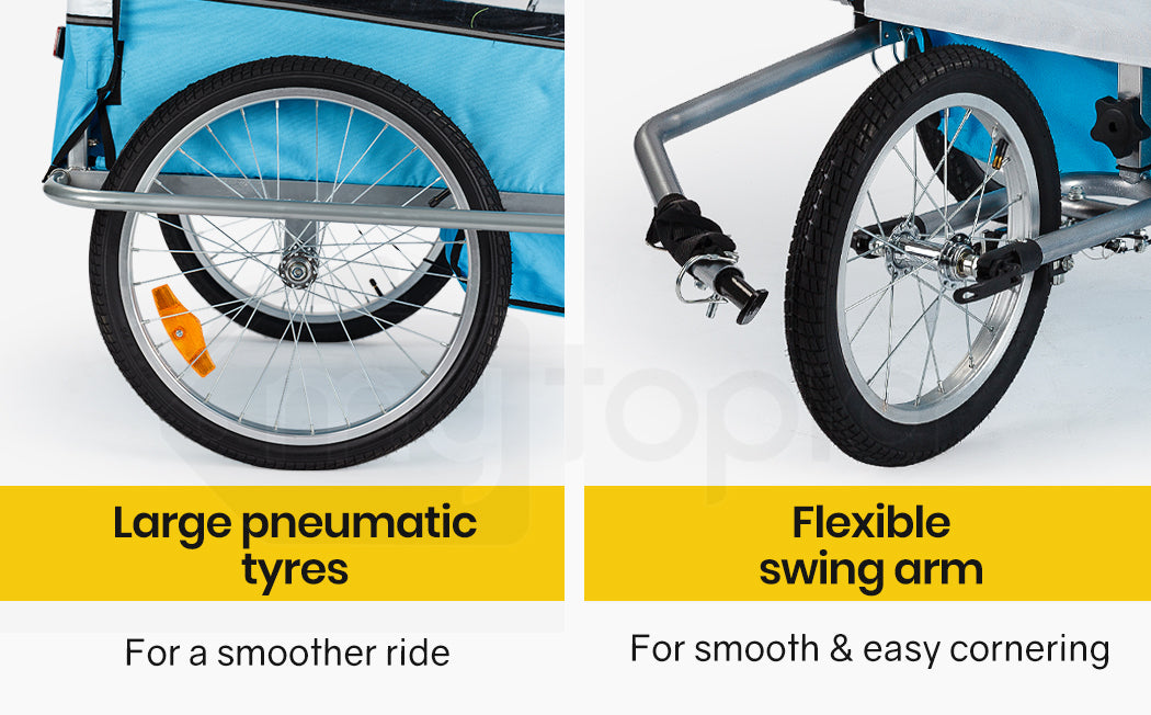 Close-up of bicycle trailer wheels with text on large pneumatic tires and flexible swing arm.