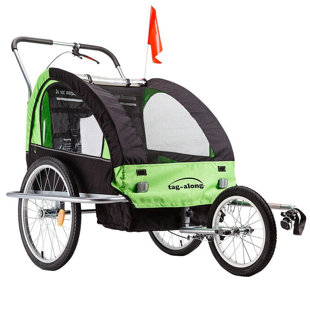 Green and black bicycle trailer with a red flag on a white background
