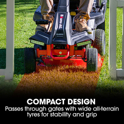 Person operating a Bumpin' A Go Go lawn mower on grass with text about compact design and wide all-terrain tyres.