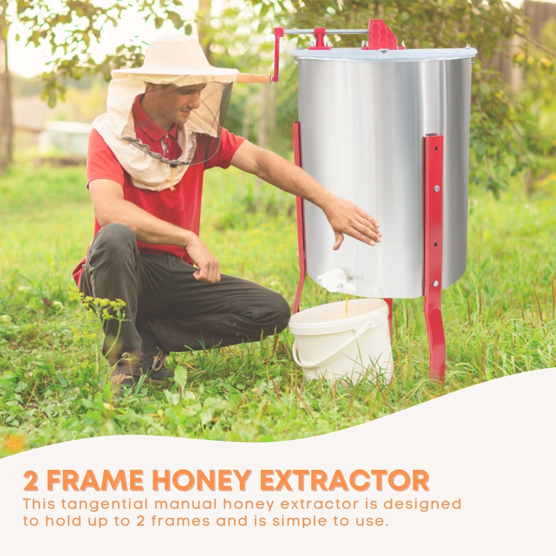 Person using a 2 frame honey extractor in a natural setting