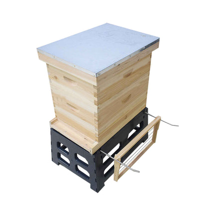 Wooden beehive with a metal top on a white background