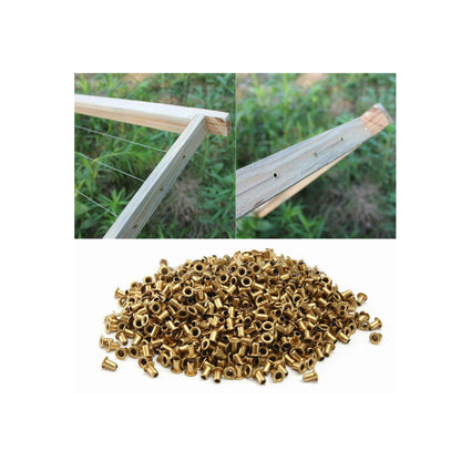 Gold metal rivets with images of wooden stakes in the background