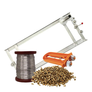 Metalworking tool set with wire spool, pliers, and brass eyelets on a white background