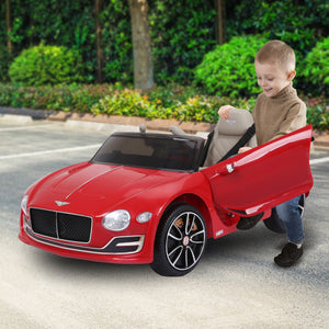 Child playing with a red toy Bentley car on a road.