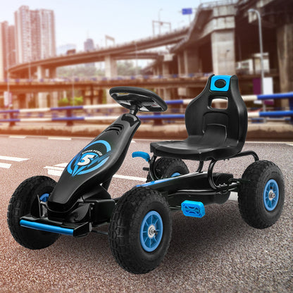 Black and blue go-kart on a road with a blurred cityscape background