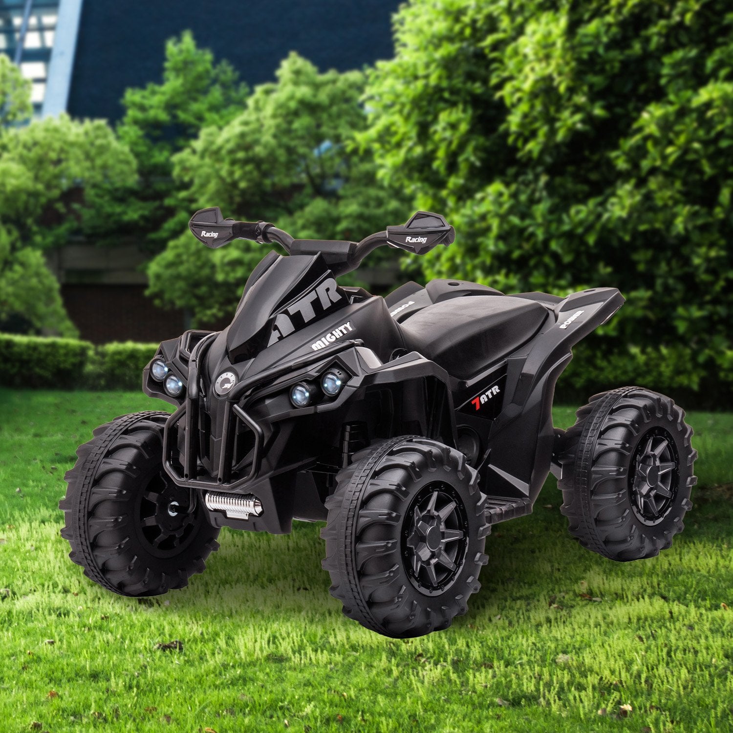 Black ATV on grass with greenery in the background