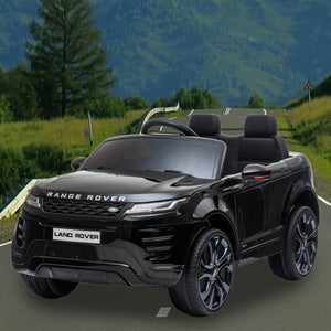 Black toy Range Rover on a road with a scenic background