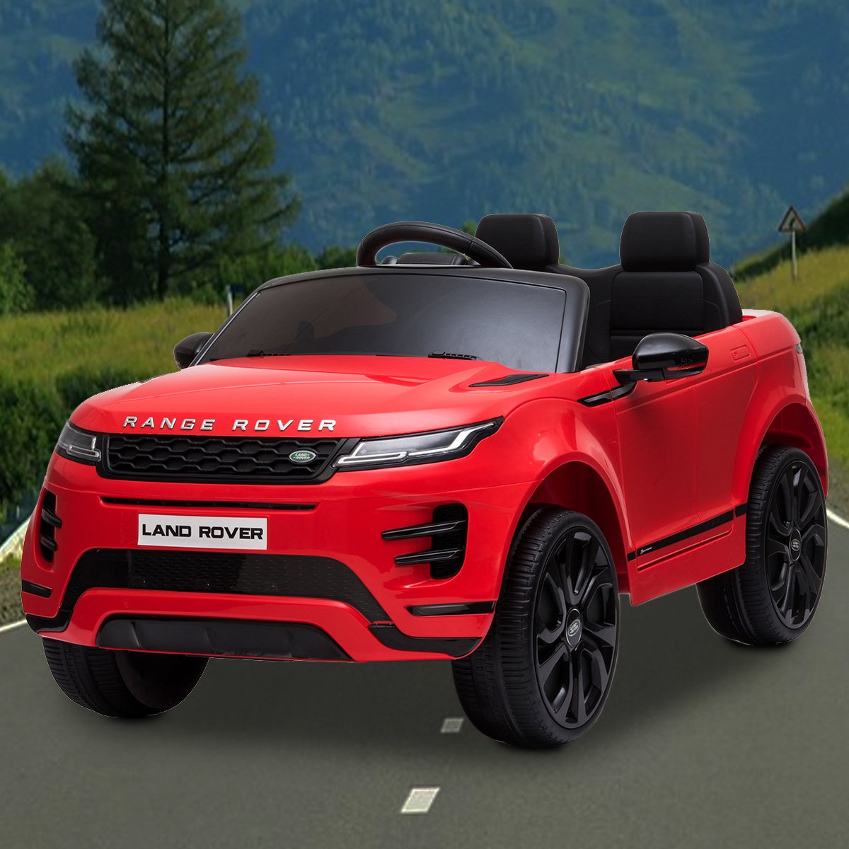 Red toy Range Rover on a road with a mountainous background