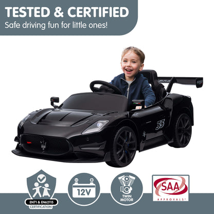 Child in a black toy car with safety certification logos on a white background