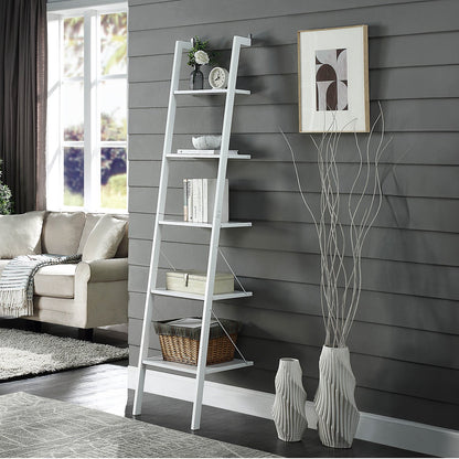 White ladder shelf against a gray wall with decorative items in a living room.