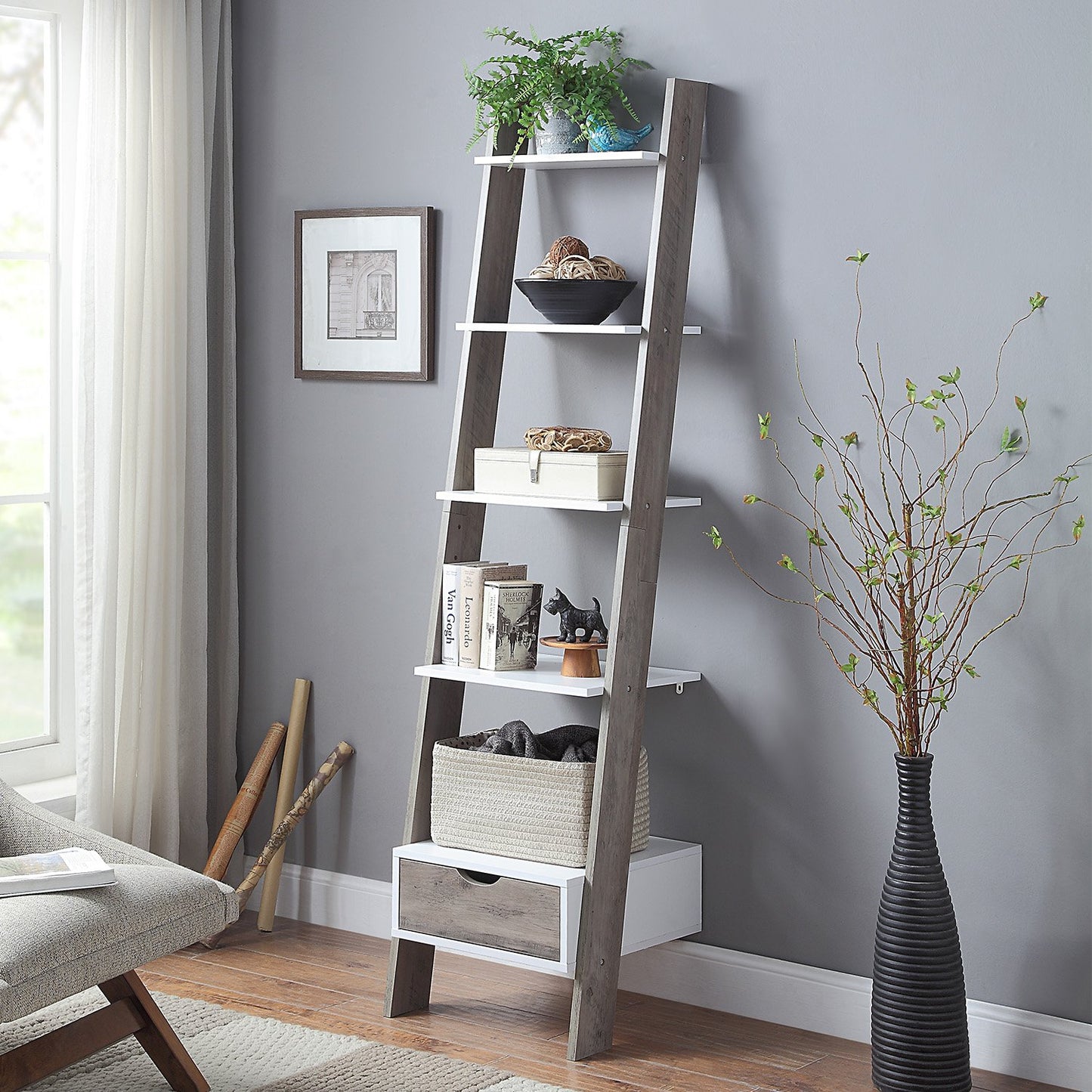 Leaning ladder shelf in a room with decor elements like a plant, vase, and books.