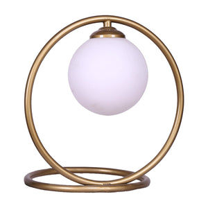 A Sarantino table lamp with a gold metal base and a globe-shaped frosted white glass shade.