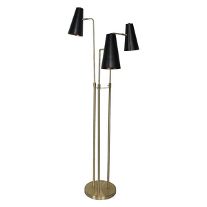 A floor lamp with three black tapered metal shades and brass poles, standing on a round base.