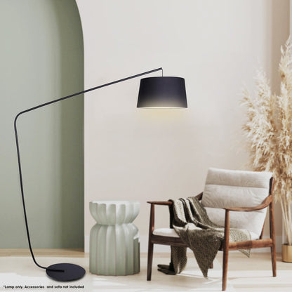 Modern floor lamp with black shade in a minimalistic room with a chair and decorative elements.