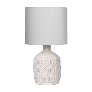 Table lamp with textured white base and gray shade on a white background