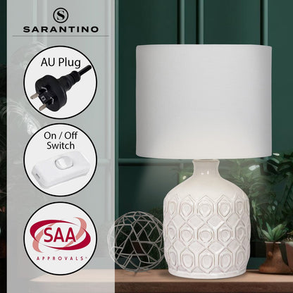 White textured table lamp with geometric design on a wooden surface, featuring Sarantino branding and product features.