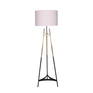 A tripod floor lamp with a gold and black gradient base and a white fabric drum shade.