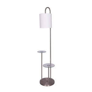 A sleek modern floor lamp with a brushed steel finish, clear glass tabletops, and a textured white fabric drum shade.