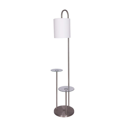 A sleek modern floor lamp with a brushed steel finish, clear glass tabletops, and a textured white fabric drum shade.