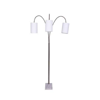 A 3-arm arc floor lamp with a brushed steel finish and a white marble base, providing overhead lighting.