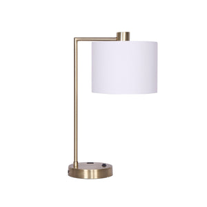 A metal task lamp with a white fabric shade and antique brass finish base, featuring a USB charging port.