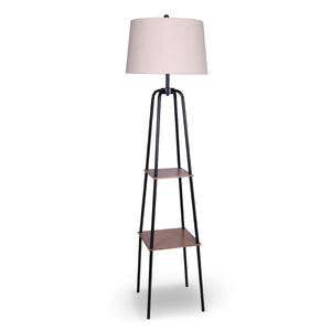 A floor lamp with a cream linen shade and wood-effect metal shelves, with black metal legs.