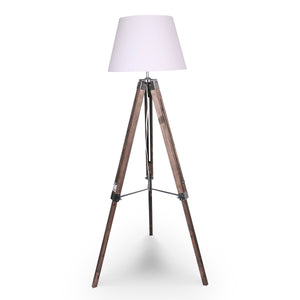 A tripod floor lamp with a white lampshade, solid wood tripod base, and metal fittings.