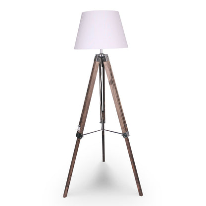 A tripod floor lamp with a white lampshade, solid wood tripod base, and metal fittings.