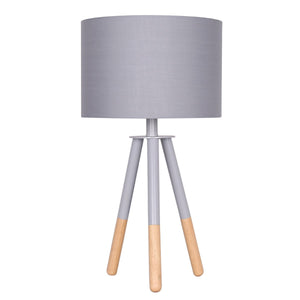A tripod desk lamp with grey painted metal legs and a fabric drum shade, featuring wooden leg tips.