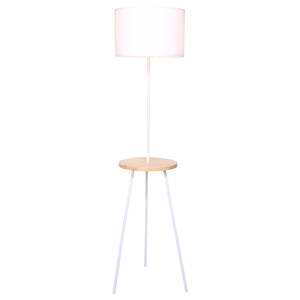 A tripod floor lamp with a white drum shade and a wooden tabletop shelf.