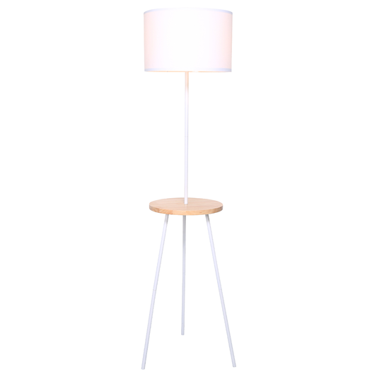 A tripod floor lamp with a white drum shade and a wooden tabletop shelf.