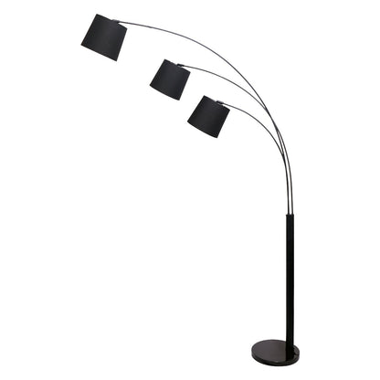 An adjustable black floor lamp with three hanging lamp shades, designed in an arc shape over a living room setting.