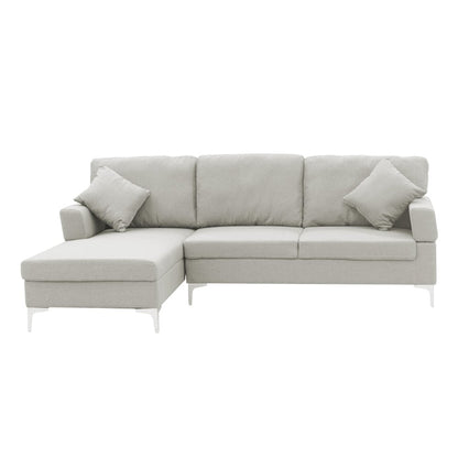 A light grey Sarantino linen corner sofa with a right side chaise, chrome-painted legs, and two cushions.