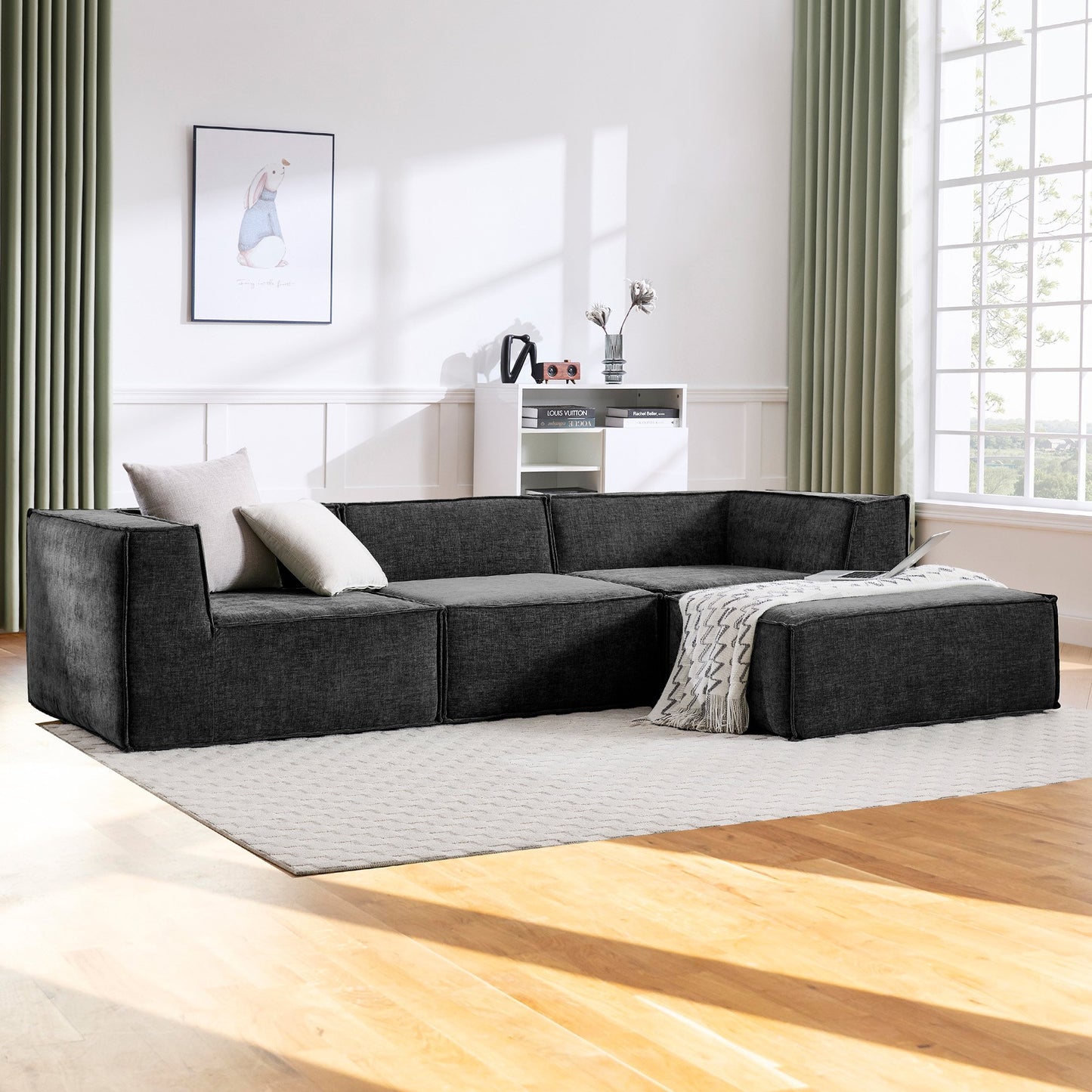 Gray sectional sofa in a modern living room with wooden floor and large window.