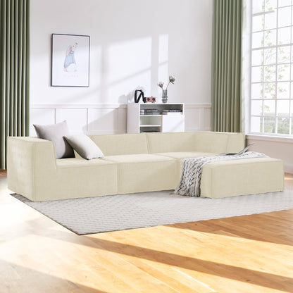 Beige sectional sofa in a modern living room with large windows and neutral decor.