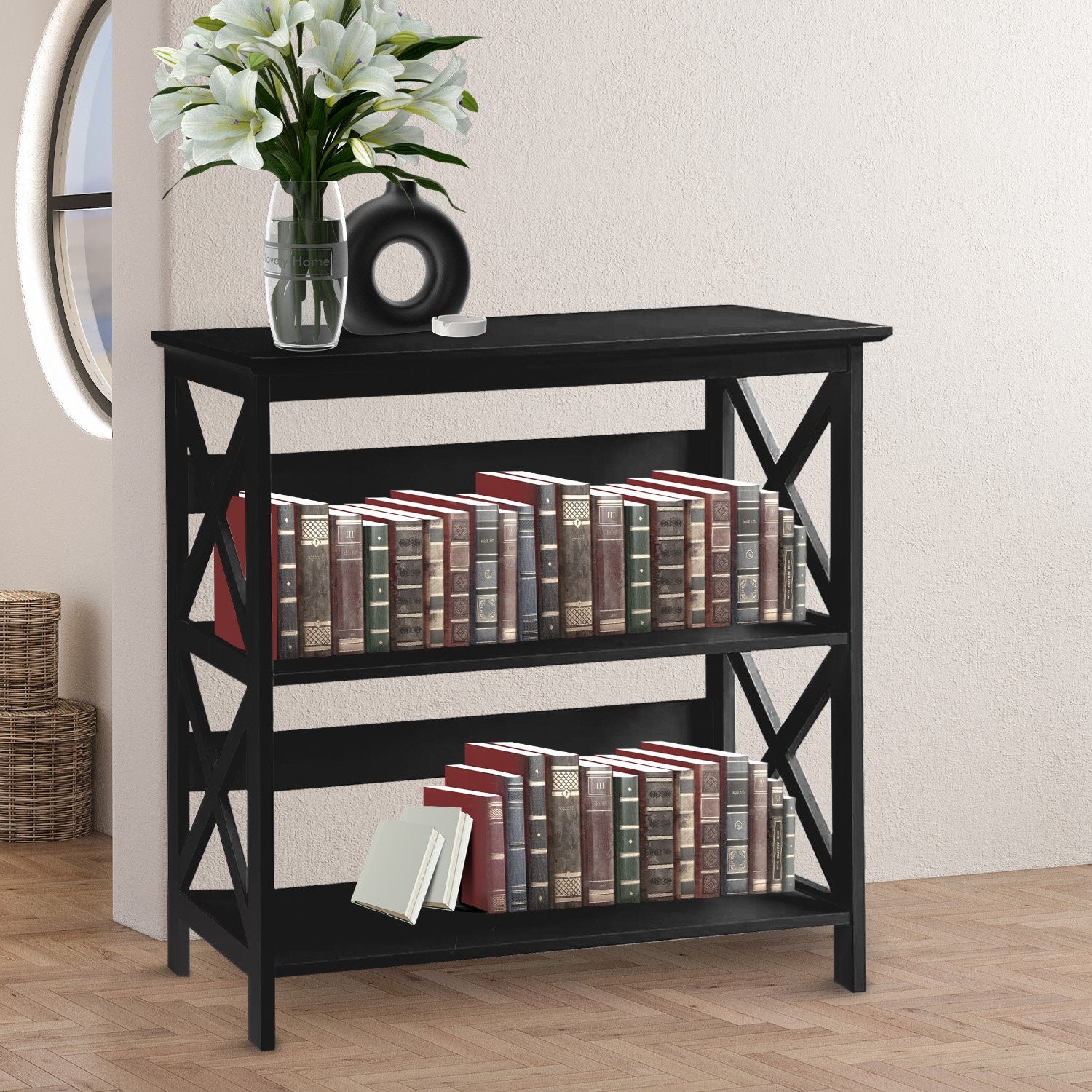 Black bookshelf with books and a vase on a wooden floor.