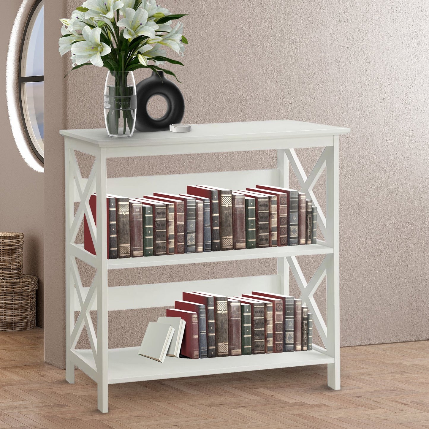 White bookshelf with books and a vase of flowers on a wooden floor.