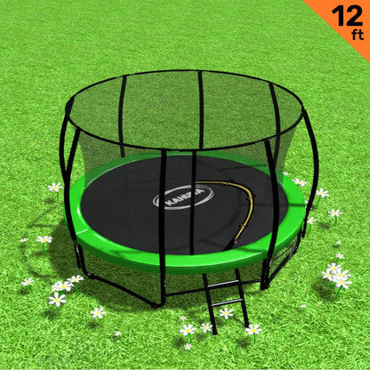 A 12 foot round trampoline with a green padding cover, safety net, and a black steel frame, placed on a grassy surface with a steel ladder beside it.
